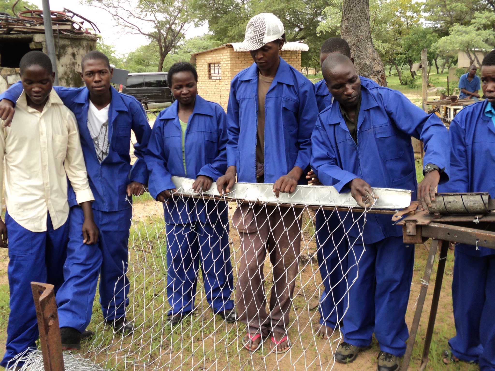 People in workwear sharing a practical skills activity
